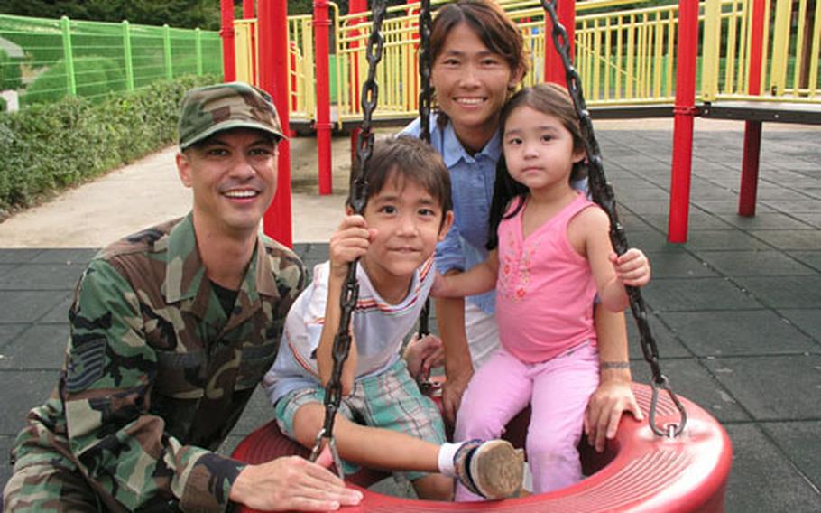 Air Force Tech. Sgt. Mike Tateishi and wife Mi-hwa with their children Ian, 5, and Erica, 3, at Osan Air Base, South Korea.