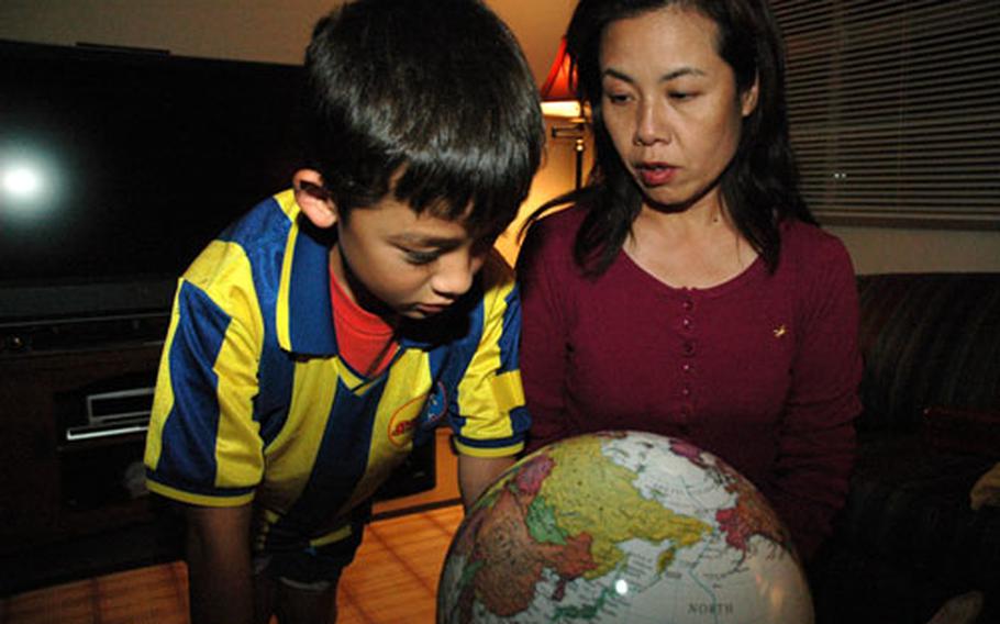 Luke Ruby, 9, and his mother, Hiroe Ruby, use a computerized globe to study about different countries around the world. Hiroe is Japanese and Luke&#39;s father, Gunnery Sgt. Troy Ruby, is American. Luke has gone to a mixture of Japanese and American schools, and this year he&#39;s in fourth grade at MC Perry Elementary School at Marine Corps Air Station Iwakuni.