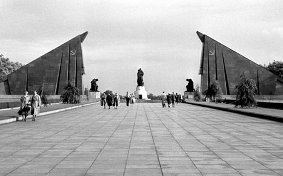 Stylized Soviet flags, made of granite taken from the ruins of Hitler's chancellery, flank the entrance of the Garden of Remembrance.