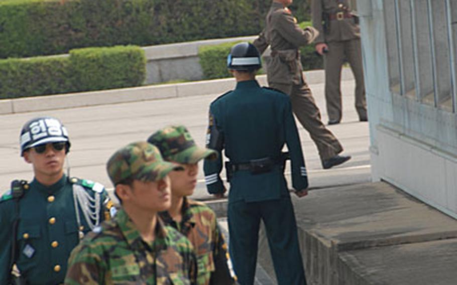 In this May file photo, South Korean and North Korean guards patrol the Demilitarized Zone near Panmunjom before South Korean officials crossed into North Korea for a meeting. According to South Korean news reports, President Roh Moo-hyun will propose during an inter-Korean summit next week that both countries withdraw their guards from the border.