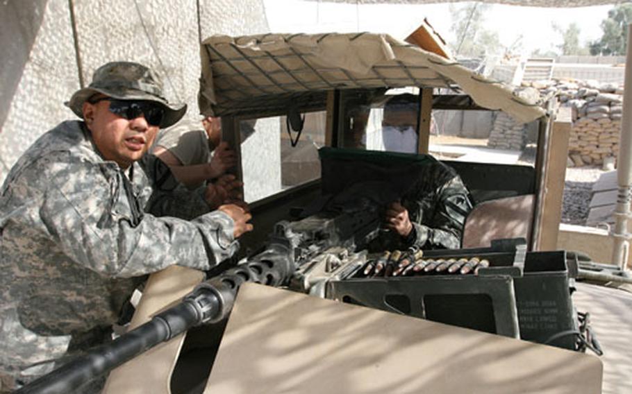 Sgt. Mabon Briola (left), 36, of Yigo, Guam, a soldier with Apache Company, 2nd Battalion, 7th Cavalry Regiment, from Fort Bliss, Texas, created a bulletproof face shield to protect Humvee turret gunners. Spc. Gabriel Hernandez, 22, of San Antonio, Texas, mans a .50-caliber machine gun behind the bullet-proof glass shield.