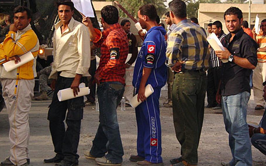 Iraqi police recruits stand in line during an all-day screening. Coalition forces are trying to help Iraq&#39;s Ministry of Interior hire thousands of new police for Baghdad in hopes of putting many of them in place before the U.S. military "surge" in forces leave early next year.