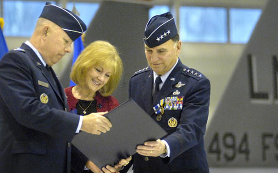 Gen. Michael Moseley, the Air Force chief of staff, left, presents a certificate of appreciation to Robbin Hobbins as her husband, Gen. Tom Hobbins, the U. S. Air Forces in Europe and NATO Air Component commander, looks at his retirement ceremony Monday at Ramstein Air Base, Germany. Hobbins, a career pilot with more than 5,000 flying hours, is stepping down after serving in the Air Force for 38 years.