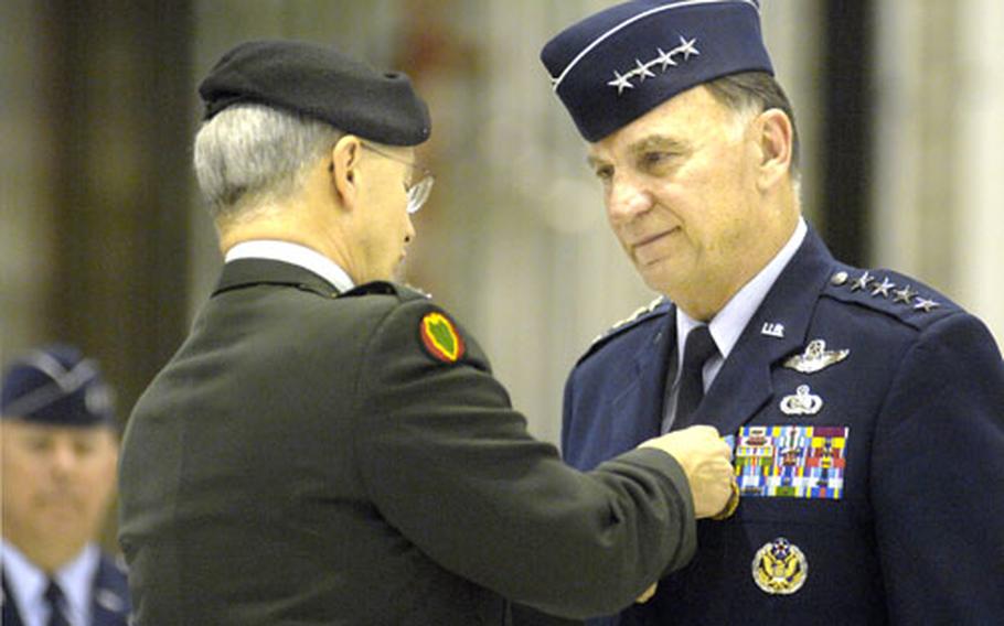 Gen. John Craddock, the commander of U.S. European Command, left, awards the Defense Distinguished Service medal and the NATO service medal to Gen. Tom Hobbins, the U. S. Air Forces in Europe and NATO Air Component commander, during Hobbins’ retirement ceremony Monday at Ramstein Air Base, Germany.