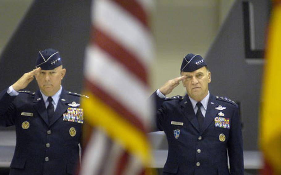 Gen. Michael Moseley, the Chief of Staff of the U.S. Air Force, left, and Gen. Tom Hobbins, the U. S. Air Forces in Europe and NATO Air Component commander, salute as the German and American National Anthems are played during the opening of Hobbins’ retirement ceremony Monday at Ramstein Air Base, Germany.