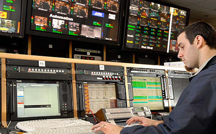 Sean Suttell, a controller, monitors U.S. TV and radio programming feeds coming into Europe Tuesday at American Forces Network headquarters in Mannheim, Germany. Even if the Hollywood writers&#39; strike continues into the new year, viewers shouldn’t notice the lack of new material for at least a few months because they get shows late anyway, according to AFN officials.