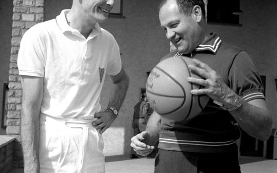 Air Force Academy basketball coach Bob Spear, right, talks over old times with his former assistant, Joe Bradley, during the 1963 USAFE clinic. Bradley was stationed at USAFE headquarters.