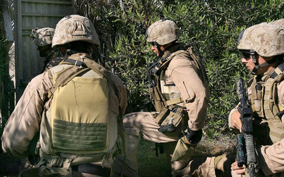 3rd Reconnaissance Battalion Marines prepare to exit a backyard on a patrol south of Fallujah, Iraq, in November 2006. A day later, the Marines conducted search-and-cordon operations in Fuhaylat, rescued one hostage and uncovered two partially-buried weapons caches.
