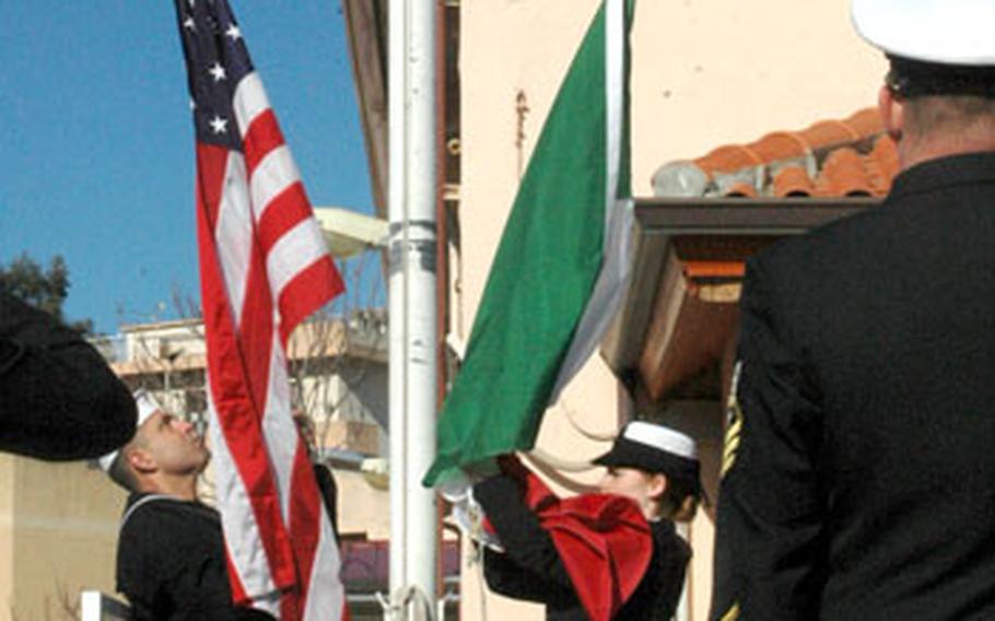 Petty Officer 1st Class Alan Wood, left, and Petty Officer 3rd Class Chelsea Mills haul down the U.S. and Italian flags for the last time Friday at the base-closing ceremony of U.S. Naval Support Activity La Maddalena.