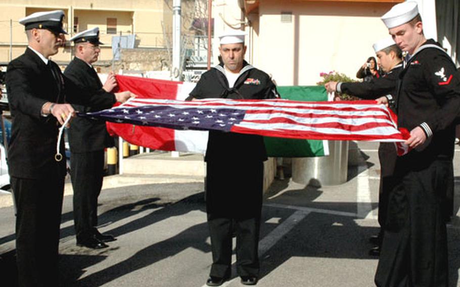 Senior Chief Petty Officer Charles Owens, left, Petty Officer 1st Class Alan Wood, center, and Petty Officer 3rd Class Garrett Snyder, fold the American flag, which later was presented to Italian Rear Adm. Ermenegildo Ugazzi, while the Italian flag was presented to U.S. Rear Adm. Michael Groothousen. Usually, leaders receive their own nation&#39;s flag during a base closure ceremony, but officials decided to break from tradition.