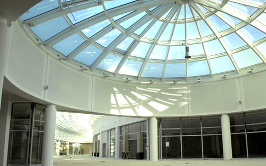 Common areas in the mall portion of the Kaiserslautern Military Community Center show signs of nearing completion on Friday. Cardboard covers the tiled floor to protect it from final construction work. Officials are hoping the 844,000-square-foot facility will be completed by the end of 2008, but have not set an opening date.