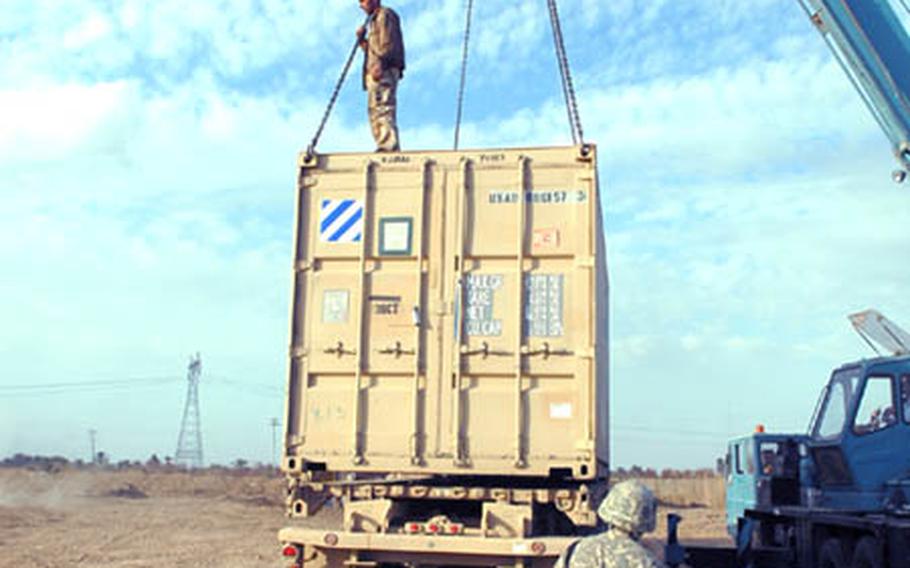 A soldier from the 1st Battalion, 15th Infantry Regiment watches as cargo is unloaded at COP Carver, southeast of Salman Pak.