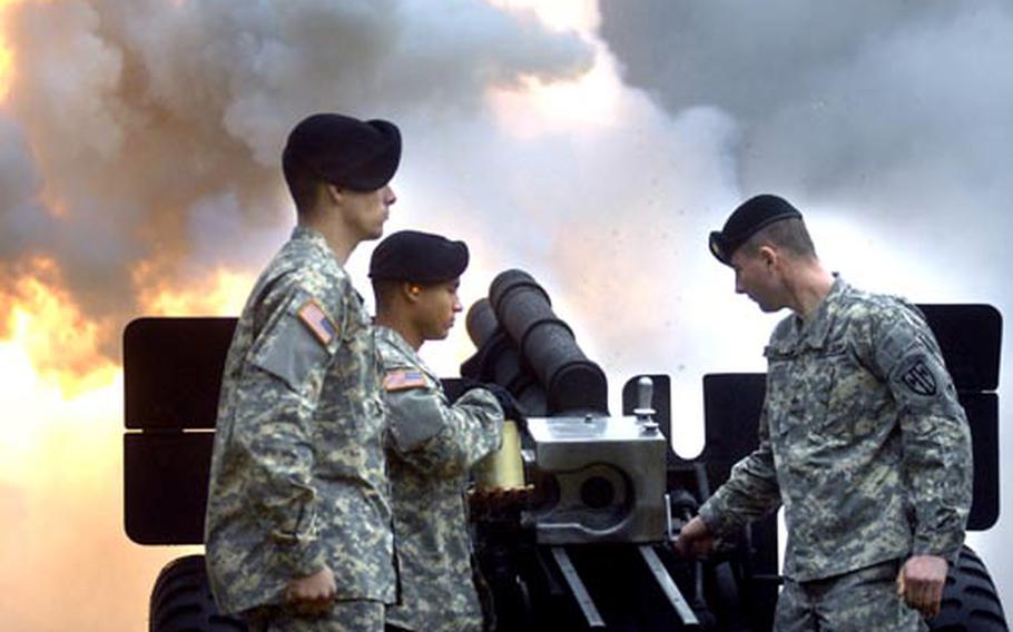 Pfc. Jovanne Montanez, Pvt. Noah Ker and Sgt. Nicholas Iafelice, left to right, members of the gun salute battery, fire a cannon at the beginning of a change of command ceremony for the 21st Theater Sustainment Command Tuesday at Danner Kaserne in Kaiserslautern.