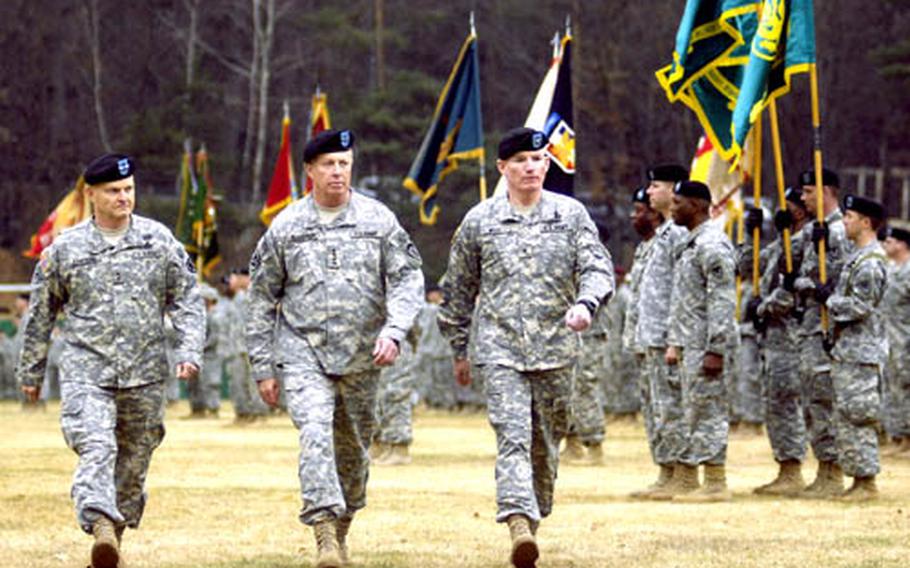 Maj. Gen. Yves Fontaine, Gen. David McKiernan, the commander of U.S. Army Europe, and Brig. Gen. Scott West review the assembled troops of the 21st Theater Sustainment Command during a change of command ceremony Tuesday at Danner Kaserne in Kaiserslautern.