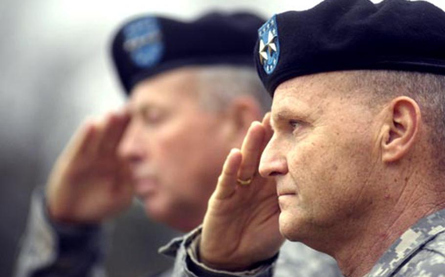 Maj. Gen. Yves Fontaine, the incoming commander of the 21st Theater Sustainment Command, renders a salute as the German National Anthem rings out during a change of command ceremony Tuesday at Danner Kaserne in Kaiserslautern. Fontaine assumed command from Brig. Gen. Scott West. Seen in the background is Gen. David McKiernan, commander of U.S. Army Europe, who served as the reviewing officer.