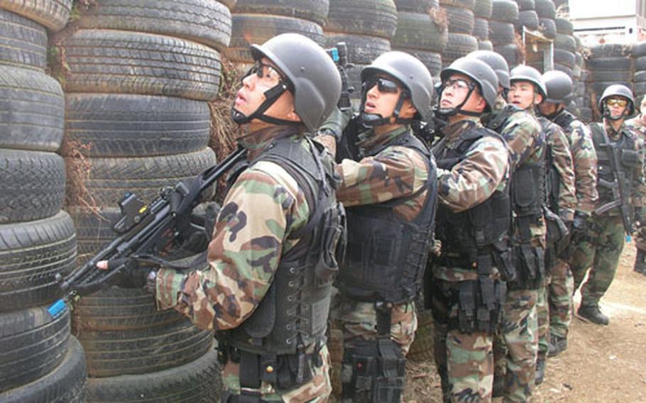 A “kill house” made of tires helps members of the South Korean navy SEALs counterterrorism unit practice how to assault and clear a house room-by-room Tuesday at Chinhae Naval Base, South Korea.