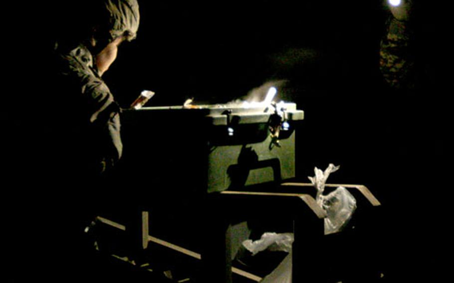 Soldiers from the 77th Engineering Company, from Fort Leonard Wood, Mo., serve up dinner under the weak glare of a flashlight at a combat outpost under construction in Mosul. The engineers move from town to town in Iraq, building the small bases for U.S. and Iraqi forces. They&#39;ve worked on 12 in recent months, including several in Mosul.