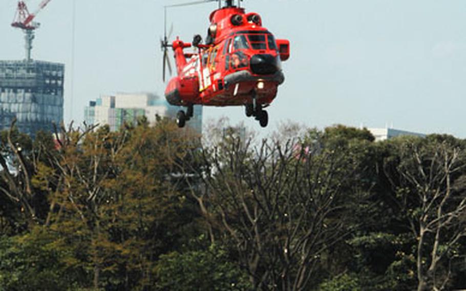 A Tokyo Fire Department helicopter prepares to land at the Hardy Barracks heliport during a training drill Wednesday. Beginning on April 1, the TFD will have access to the heliport to evacuate patients from islands near Tokyo to downtown hospitals.