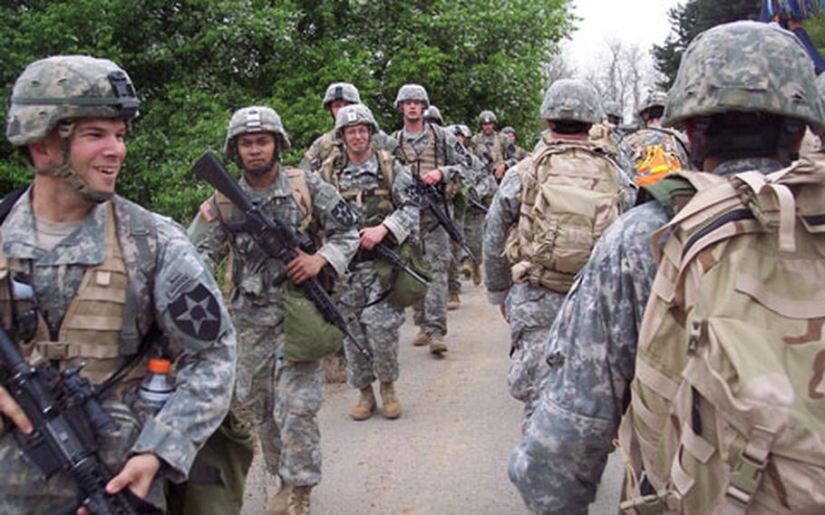 Soldiers taking the opposite route encounter the command group around the halfway point of the 25-mile “Manchu Mile” hike near Warrior Base, South Korea, on Tuesday. The event is a tradition of the 2nd Infantry Division’s 2nd Battalion, 9th Infantry Regiment. It commemorates an 85-mile hike and battle by the regiment during the Chinese Boxer Rebellion in 1900.