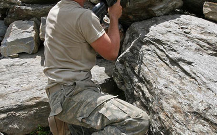 Sgt. Stephen Guthrie, 22, of Eaton, Ohio, keeps a watchful eye with a M249 Squad Automatic Weapon in Gowardesh Valley in east Afghanistan’s Nuristan province.