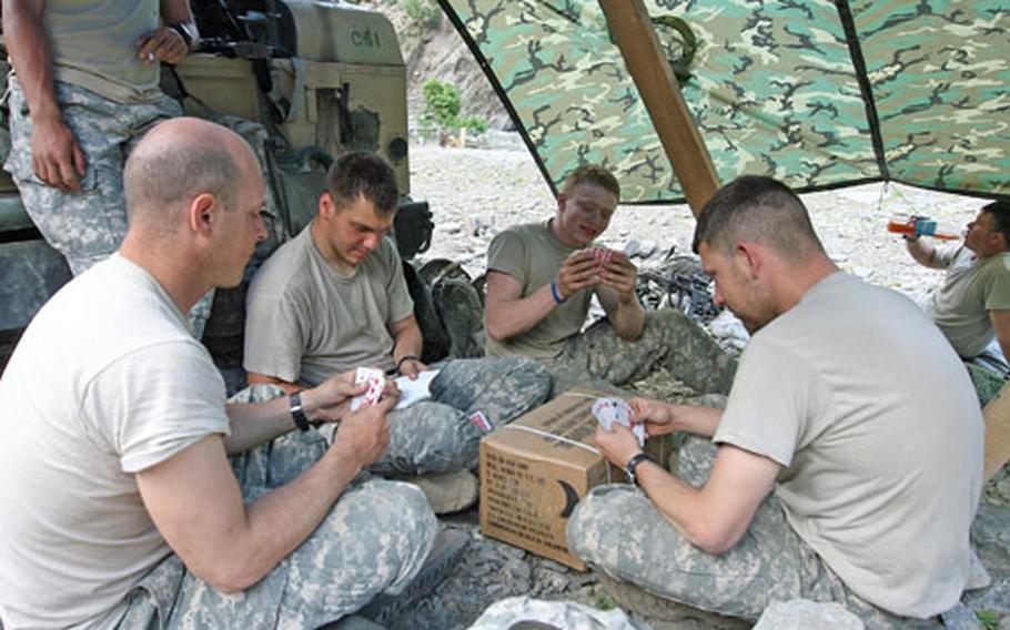 From left, Staff Sgt. John Fin, Spc. Michael Hardy, Pfc. Quentin States and Sgt. Wesley Faudree of Task Force Saber play cards while passing time in the Gowardesh Valley.