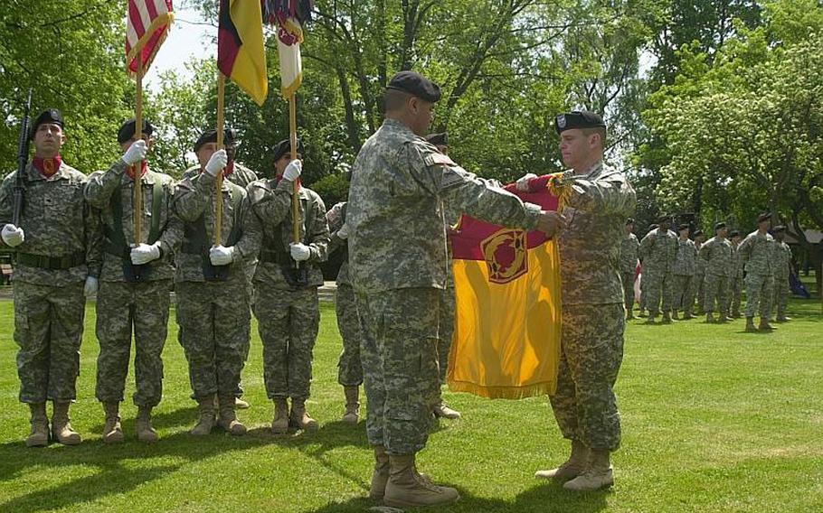 Col. Joseph Fischetti, commander of the 69th Air Defense Artillery Brigade, right, and Sgt. Maj. David Gonzales, the brigade’s acting command sergeant major, prepare the unit&#39;s colors for casing during a ceremony at the former Victory Gardens Park on Leighton Barracks in Würzburg, Germany, on Tuesday. After serving more than half a century in Germany, the brigade is furling its Colors for its eventual move to Fort Hood, Texas, in June.