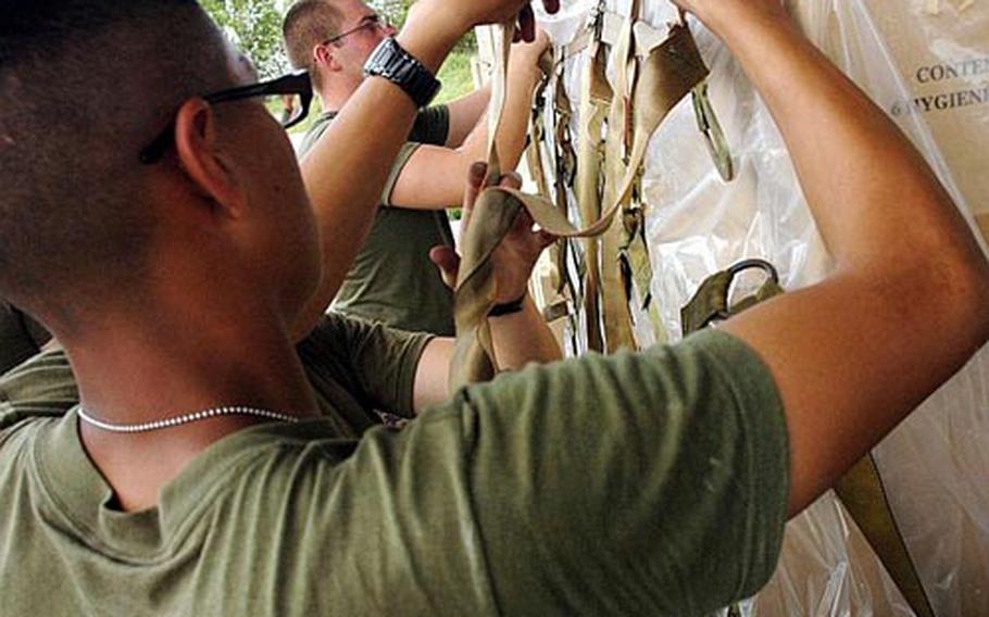 Okinawa-based Marines prepared boxes of hygiene kits for victims of Cyclone Nargis at Utapao Air Base in Thailand Tuesday but questions remain about when the boxes will be delivered due to the wait for approval by Myanmar&#39;s military junta.