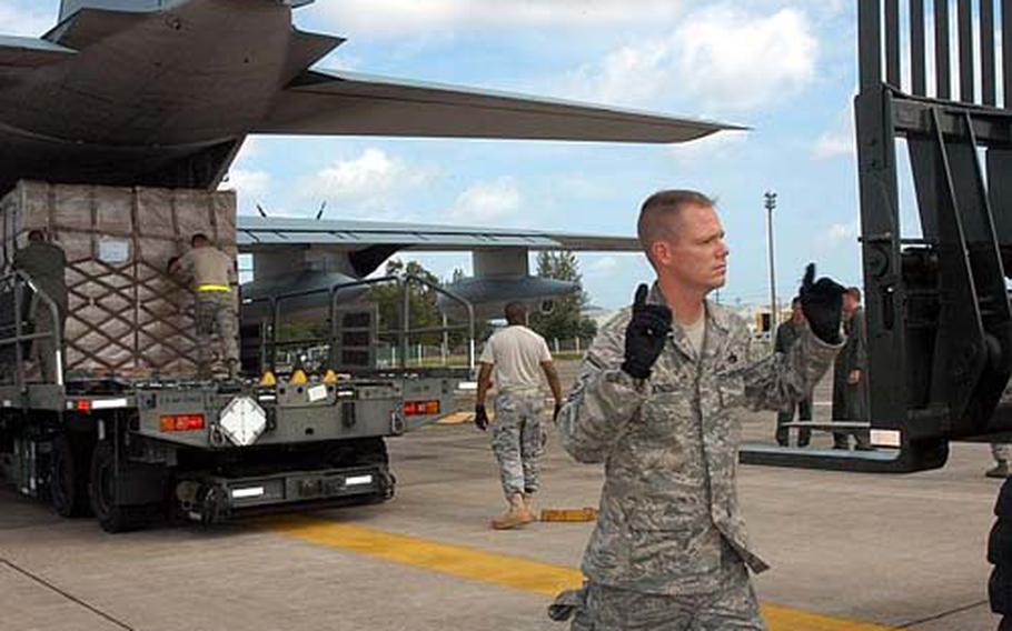 Two more C130 flights landed Tuesday in Myanmar&#39;s Yangon city carrying water, mosquito netting, blankets and plastic sheeting for Cyclone Nargis victims. U.S. Air Force aerial porter MSgt. Todd Kneisley directed the forklift.