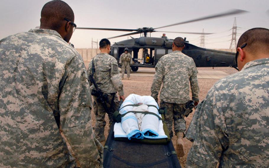 Sgt. Dontre Robinson, Spc. Christopher Pay, Sgt. 1st Class James Toone and Sgt. George Alonzo, from the left, all combat medics for 1-35 Armor, carry Mariam, a seven month old Iraqi child, to a Blackhawk for evacuation to a hospital at Balad Air Base on Sunday from Jisr Diyala, Iraq.