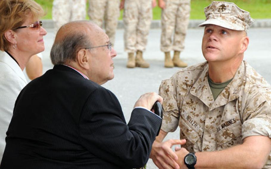 Maj. Gen. Robert B. Neller, commander of 3rd Marine Division, talks with Elke Morris and Dr. H. Pierre Secher before the start of a ceremony to honor their son Capt. Robert M. Secher, who was killed in Iraq in October 2006.