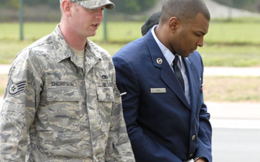 Airman Nicholas Sims, right, of Ramstein Air Base&#39;s 86th Maintenance Squadron enters the court building aside his escorts Friday just minutes before being sentenced for his role in the 2005 gang-beating death of Army Sgt. Juwan Johnson.