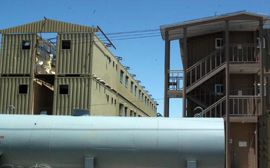 The majority of troops stationed at Bagram Air Base in Afghanistan will be living in a series of re-locatable barracks within two years. Metal containers are stacked up two or three stories high, as on the left, and gradually transformed into living quarters such as the one on the right.