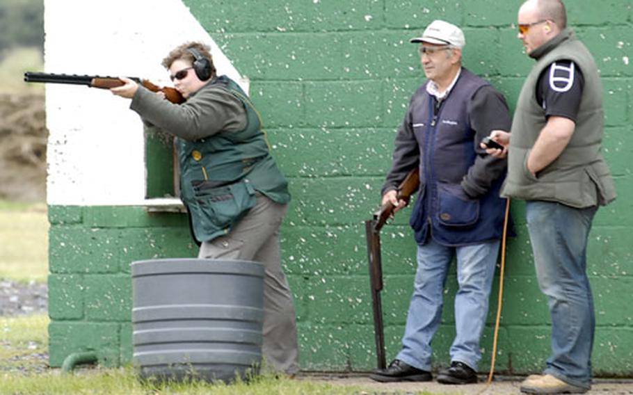 Jenna Keys takes aim at a clay pigeon during a recent visit to the Lakenheath Shooting Ground and Clay Target Centre while her shooting partner Peter Bloomfield looks on and her husband, Lewis Keys, operates the target pull.