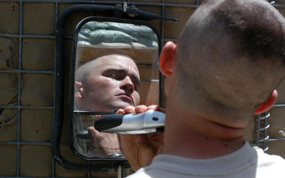 Spc. Jason Leehan, the platoon medic, improvises for his morning shave.