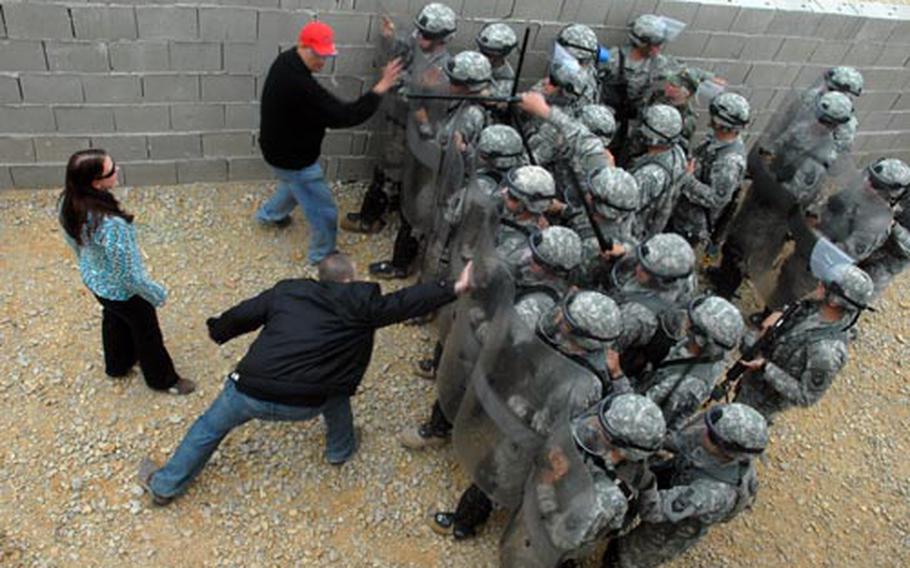 MPs from the Kosovo-bound 3175th Military Police Company, Missouri National Guard, attempt to suppress a mock riot at Hohenfels, Germany, on Tuesday.