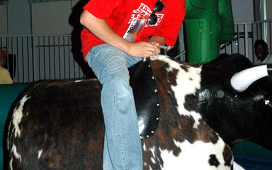 A Yokota High School graduate tries his luck on the mechanical bull.