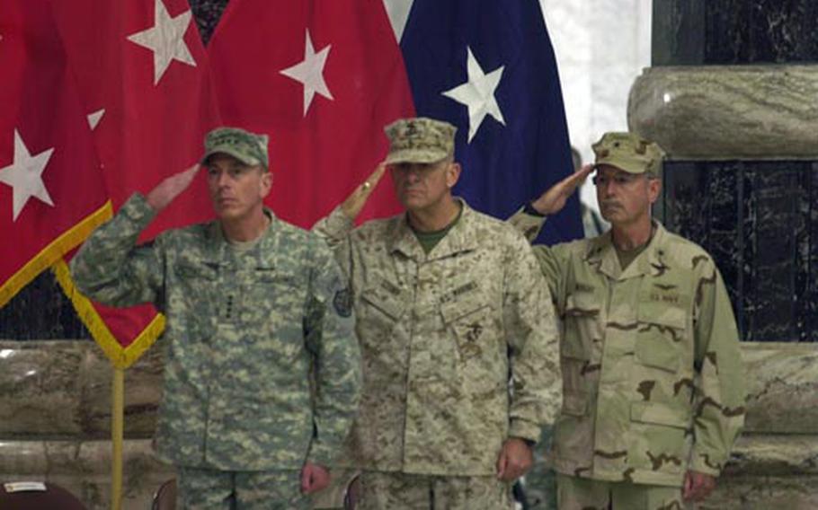 From left: U.S. commander in Iraq Gen. David Petraeus; outgiong detainee operations commander Maj. Gen. Douglas Stone; and incoming detainee operations commander Rear Adm. Garland Wright salute during the presentation of colors Friday in Baghdad.