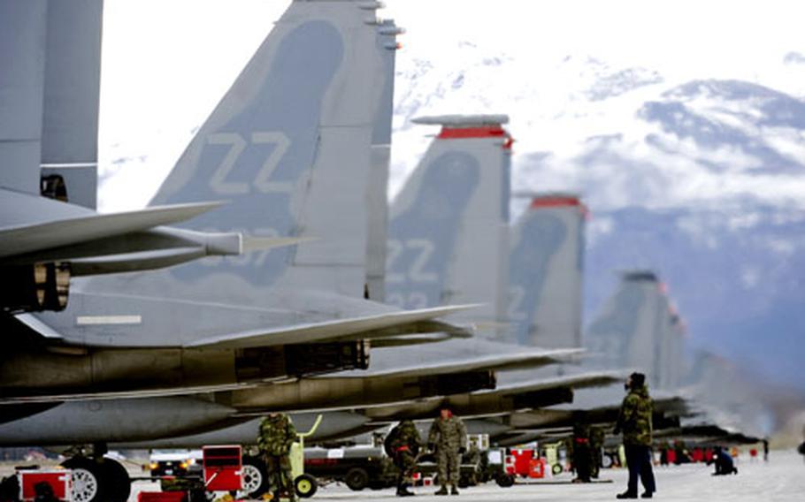Crew chiefs from Kadena Air Base conduct a pre-flight checklist on an F-15 Eagle at Elmendorf Air Force Base in Alaska.