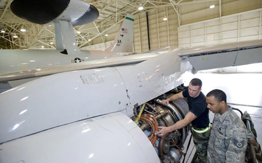 Staff Sgt. Bridger Morris, left, of the 703rd Aircraft Maintenance Squadron explains the engine compartment on an E-3 Airborne Warning and Control System to Staff Sgt. Alonzo Deon of the 718th Aircraft Maintenance Squadron at Elmendorf Air Force Base in Alaska.