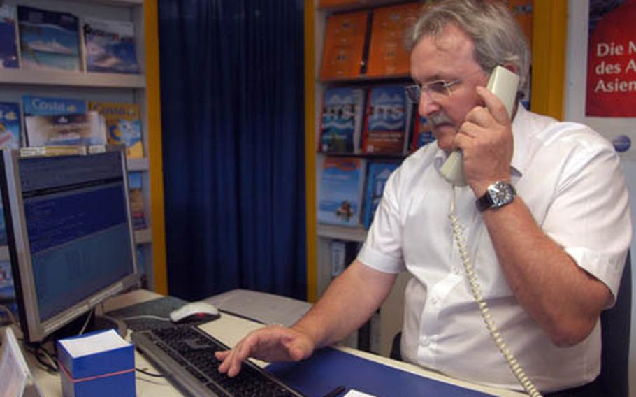 Herbert Blesinger, owner of ABC Travel Service, takes a call Saturday from a customer inquiring about airfares. ABC has offices near U.S. military communities across Germany. Blesinger said the cheapest seats on flights to the States this summer will be well above last year’s prices during the high season — typically June through August.