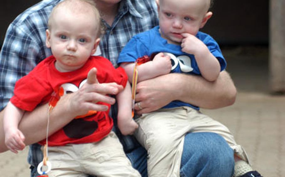 Air Force Master Sgt. Aaron Norfleet holds his twin sons, Zeke (left) and Eli, at a reunion Saturday hosted by the Landstuhl Regional Medical Center’s neonatal intensive care unit.