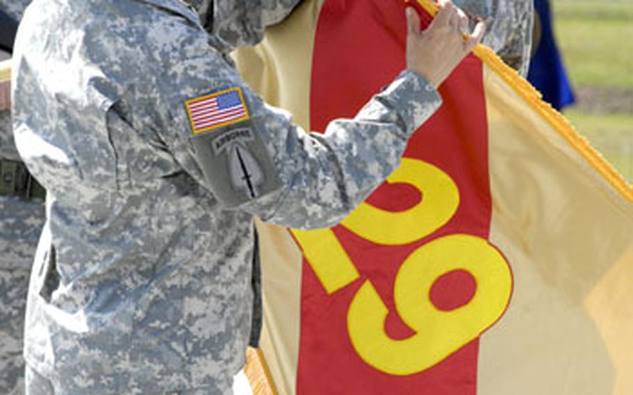 Army Col. Robin Akin, commander of the 29th Support Group, left, and Command Sgt. Major Angel Clark-Davis "case" the group&#39;s flag as part of the deactivation ceremony.