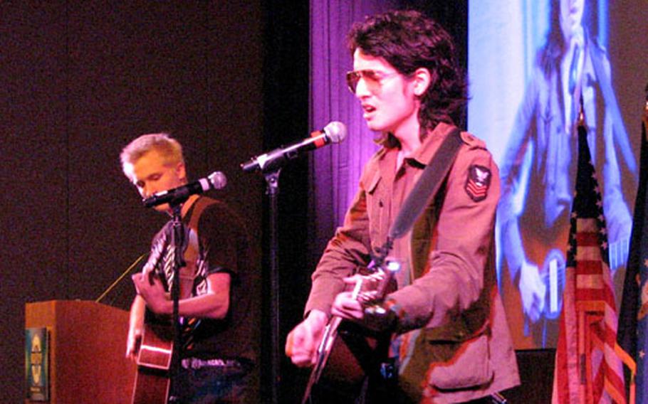 Brian Walters (right) and Jordan Krunich of the group "12 Strings" cap off the week-long Navy Child and Youth Programs Conference in Tuscan, Ariz. with an acoustic performance in front of a packed ballroom. The two joined six others in traveling to the States to represent the Yokosuka Naval Base Teen Center&#39;s music program.