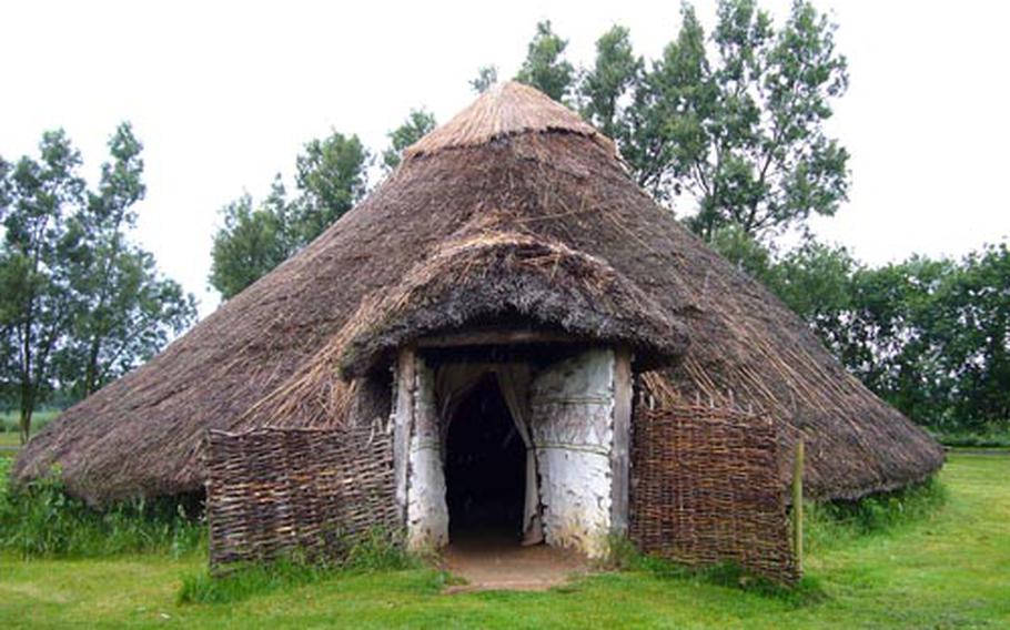 A reconstructed Iron Age roundhouse allows visitors to explore how ancient people lived at the archaeological site.
