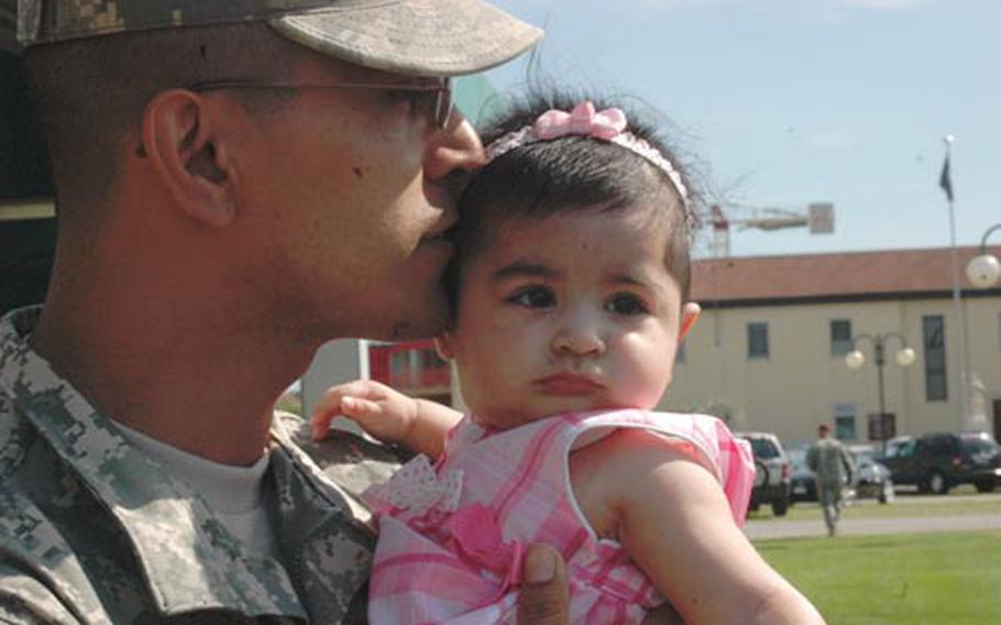 Staff Sgt. Francisco Lopez, with Company A, 2nd Battalion, 503rd Infantry Regiment, 173rd Airborne Brigade Combat Team kisses his 6-month-old daughter, Milana, who barely fit in both of his hands last time he saw her five months ago. Lopez and roughly 50 soldiers from the 173rd returned to Caserma Ederle, in Vicenza, on Thursday after a deployment to Afghanistan.