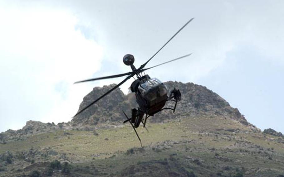 A Kiowa warrior helicopter swings away from a mountain ridge after checking for insurgents Saturday during a firefight near the Afghan village of Tut Naw. A pair of Kiowas engaged insurgents who had been in a firefight with Afghan and American forces earlier in the morning. At least seven insurgents were killed.