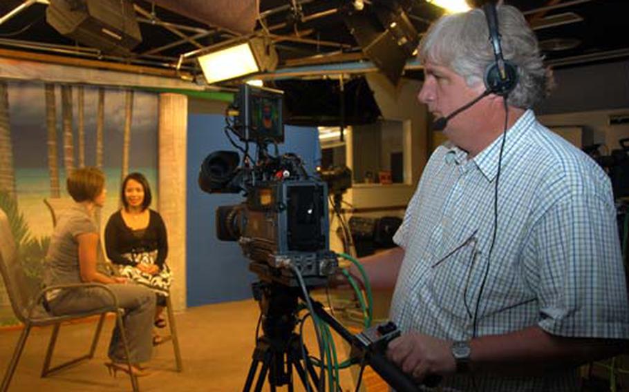 Kadena Services TV producer Joe Brown tapes the“Highlights” show, featuring host Jennifer Almendarez and guest Nicole Huston, left, a human resources assistant on Kadena Air Base, Okinawa. Services TV is an independent channel available on military bases in Okinawa that promotes events and activities around the air base.