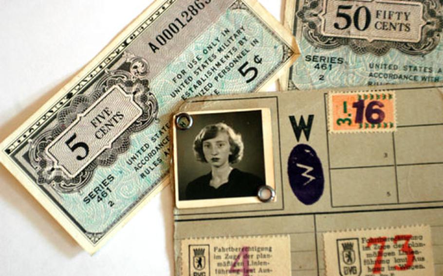 Sixty years ago, Traute Grier used this transportation pass to make her way around postwar Berlin. Alongside the pass are a pair of old U.S. military payment certificates from that era.