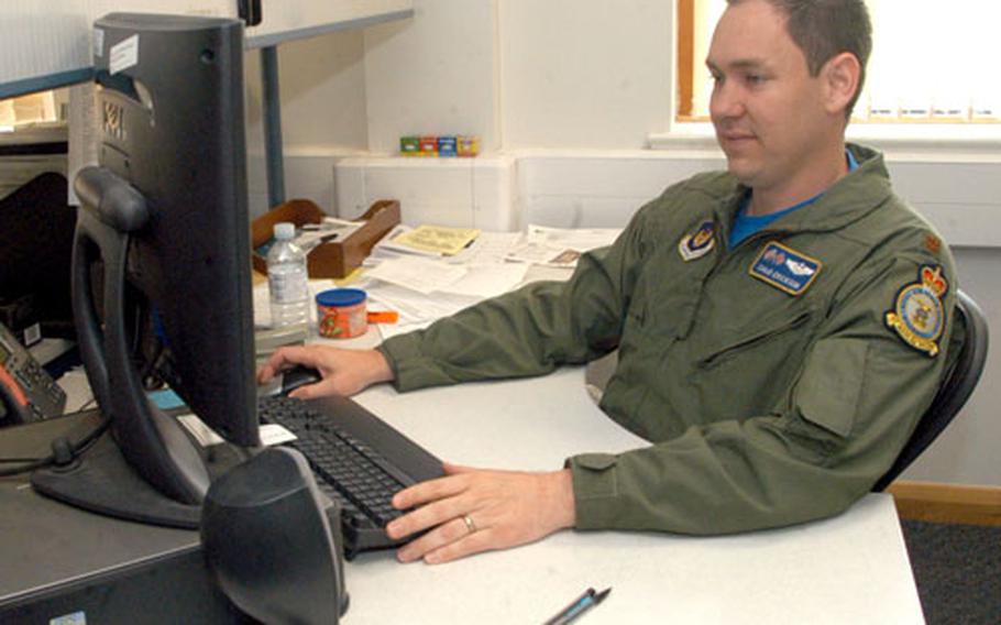 Maj. Chad Erickson, of the 100th Operations Support Squadron, finishes up some last-minute work before heading to the States on Saturday to donate his bone marrow to a leukemia patient.
