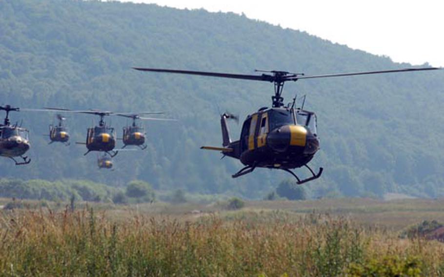 U.S. Huey helicopters prepare to drop German troops during air assault training Wednesday at Hohenfels, Germany.